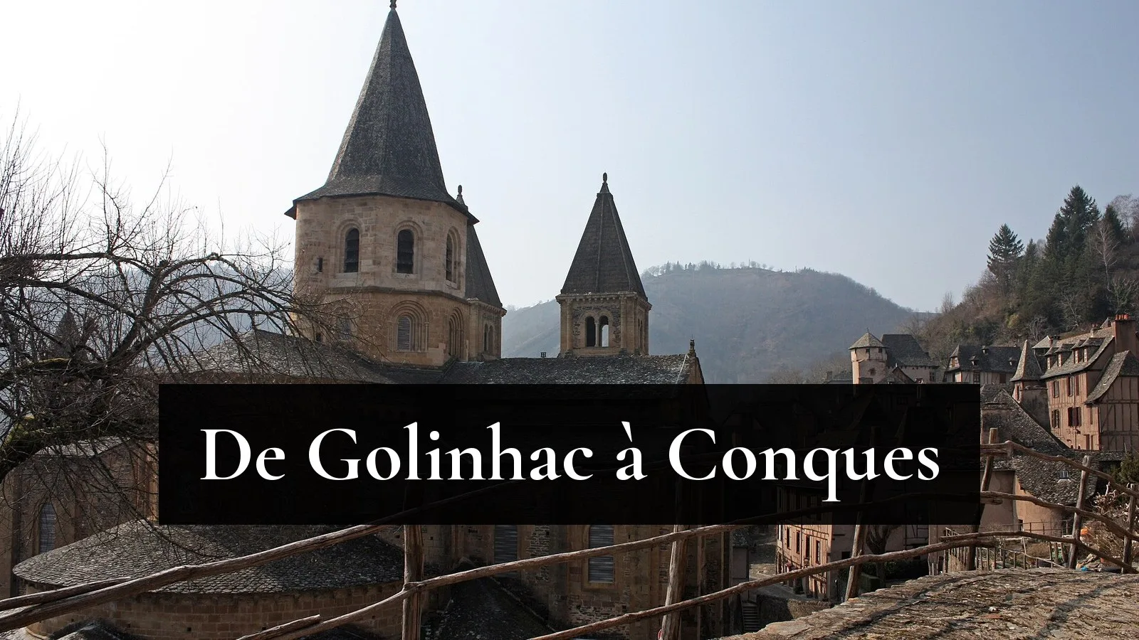 L'abbatiale Sainte-Foy de Conques et les maisons du village, vues depuis le chemin de Saint-Jacques par lequel les pèlerins du GR65 arrivent de Golinhac